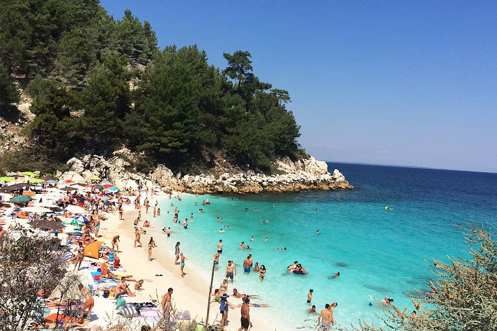 People taking bath at beautiful Marble beach Thassos 